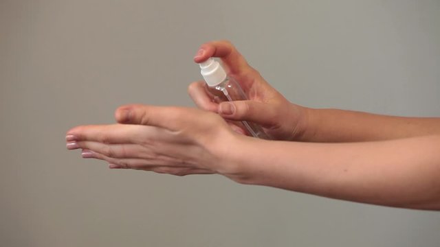 Hand Disinfection. Woman Disinfects Her Hands With An Antiseptic Spray Agains