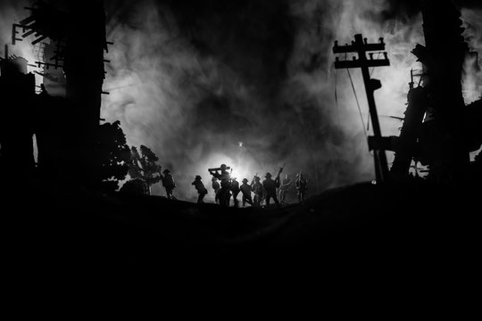 War Concept. Military silhouettes fighting scene on war fog sky background, World War Soldiers Silhouette Below Cloudy Skyline At night.