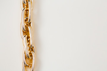 Fototapeta premium massive golden braided chain bracelet on a white background in isolation copy space place text