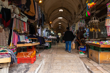A street with shops selling fabrics and souvenirs leads from the Arab market to the Bab al-Qattaneen - Gate of the Cotton Merchantsis of the Temple Mount in Jerusalem in Israel