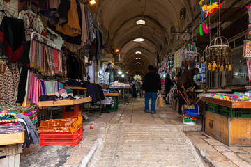 A street with shops selling fabrics and souvenirs leads from the Arab market to the Bab...