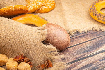 Chocolate cakes, bagels and cookies on a background of coarse fabric. Close up.