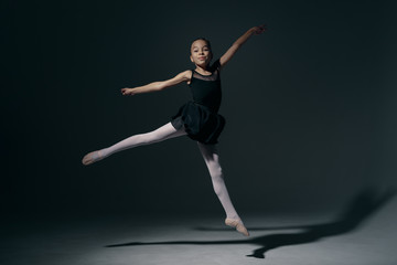 Fototapeta na wymiar Delicate girl ballerina dancing in studio