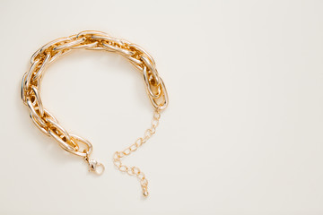 massive golden braided chain bracelet on a white background in isolation copy space place text