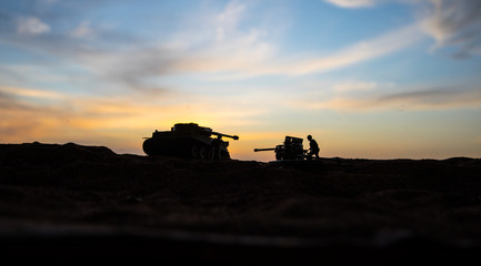 Fototapeta premium War Concept. Military silhouettes fighting scene on war fog sky background, World War Soldiers Silhouette Below Cloudy Skyline At sunset.