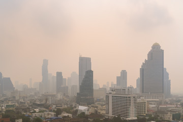 Fototapeta na wymiar Unhealthy air pollution in Bangkok city business district, pollute with PM 2.5 dust, smog or haze, low visibility