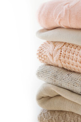 Stock Photo - Stack of cozy knitted sweaters