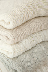 Fototapeta na wymiar Stock Photo - Stack of cozy knitted sweaters