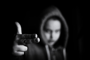 B&W image of gangster kid with finger gun pointed in camera