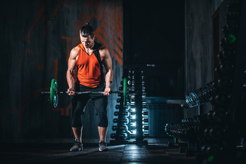 young athlete has physical workout with barbell in modern gym