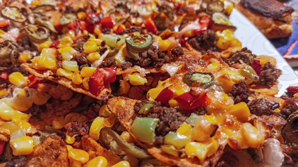 Mexican nachos tortilla chips with cheddar and jalapeno. Homemade  traditional mexican food served with cheddar cheese and jalapenos. 