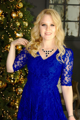 happy blonde woman near xmas tree