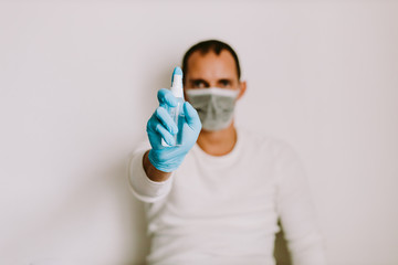 man using liquid hand sanitizer during quarantine at home