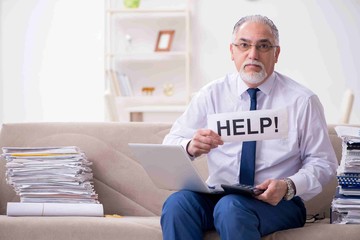 Aged businessman employee working from house