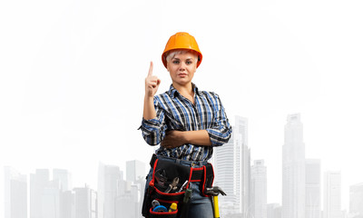 Beautiful female builder in hardhat