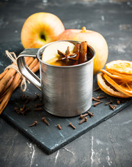 Apple cider in metal mug on the rustic background. Selective focus. Shallow depth of field.