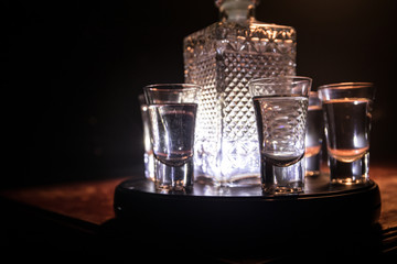 Vodka in bar on a glass table, focus on glass. Club drink concept.