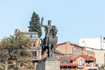 Fototapeta premium The Statue of King Vakhtang Gorgasali and Metekhi St. Virgin Church in Tbilisi city in Georgia