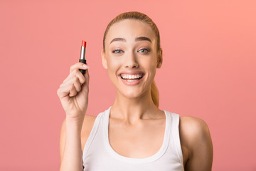 Obraz premium Excited Girl Holding Lipstick Smiling Posing Over Pink Background