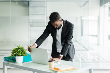 Happy african businessman open laptop while start work at office