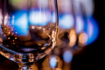 Wine and martini glasses in shelf above a bar rack in restaurant. 