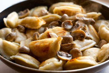 homemade fried dumplings with mushrooms in a pan