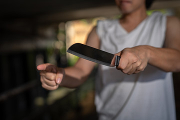 The criminal is using a threat knife to steal.