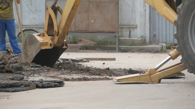 Excavator digs  trench in the construction site. Works on laying communications.