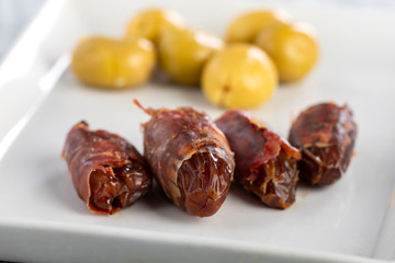 spanish dates with ham on a plate