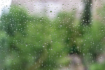 Drops of rain on the window with sky background
