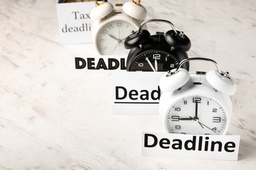 Alarm clocks with words DEADLINE on white background
