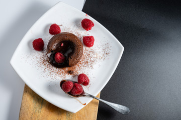 French dessert, chocolate volcano or coulant on a white plate, baked cake with delicious melted...