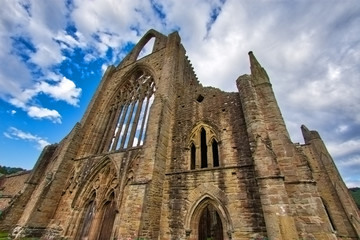 Fototapeta premium The ruins of Tintern Abbey, founded by Walter de Clare, Lord of Chepstow, on 9 May 1131. It is situated adjacent to the village of Tintern in Monmouthshire, Wales, UK.