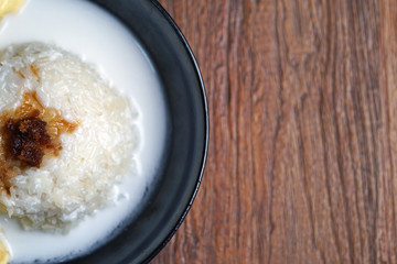 'Pulut Durian' is a glutinous or sticky rice with durian, coconut milk and sprinkle of grated palm sugar-selective focus