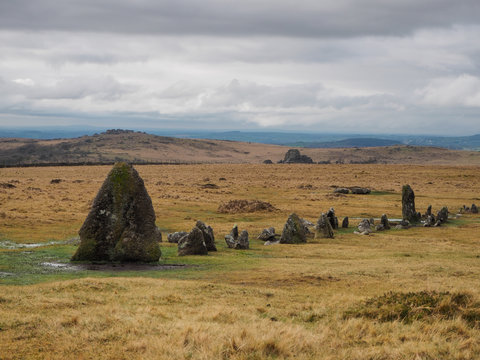 Bronze Age standing Stone Rows at Merrivale Prehistoric site with Vixen Tor in the background and storm clouds overhead, Dartmoor National Park, Devon, UK