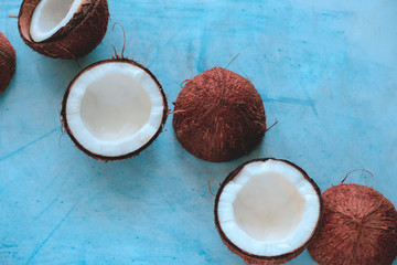 top view layout of fresh coconuts on a blue background