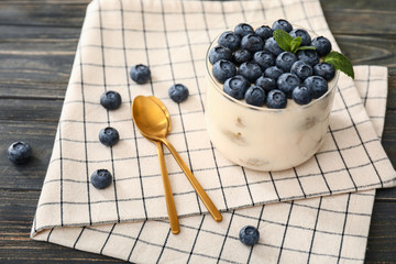 Tasty tiramisu with berries on table