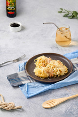 Spaghetti cream cheese white sauce with salmon Italian cuisine in gray plate