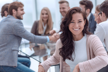smiling business woman sitting in front of the table in the meeting room