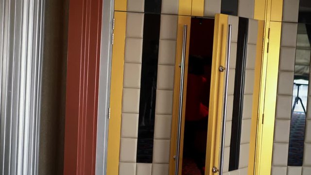 The African woman is rushing into a movie theater because she is late