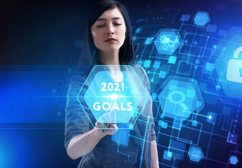 Business, Technology, Internet and network concept. Young businessman working on a virtual screen of the future and sees the inscription: 2021 goals