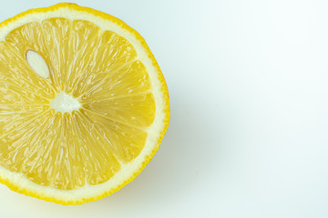 Sliced fresh lemon for summer drink on white background.