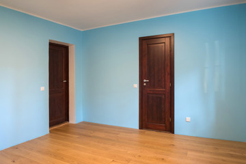 New home construction interior room with wooden floors and wooden doors