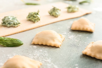 Preparing of tasty ravioli on table