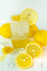Fresh lemon soda drink iced with lemon sliced on white background.