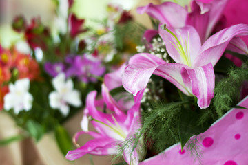 Beautiful pink lilies in a gift box. Bouquet of flowers with lilies.