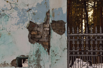 Old concrete fence. Old brick walls. Texture. Brickwork. Shabby fence with damaged stucco.