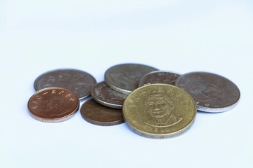 Heap of Chinese Taipei dollars coin money on the white background. Concept of finance.