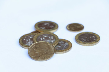 Heap of French franc coin money on the white background. Concept of finance.
