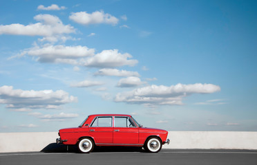 Red retro car VAZ-2103 "Zhiguli" parked on the road against the background of the sunny sky at Old Car Fest show, JULY 4, 2016 in Kiev, Ukraine. Space for text.